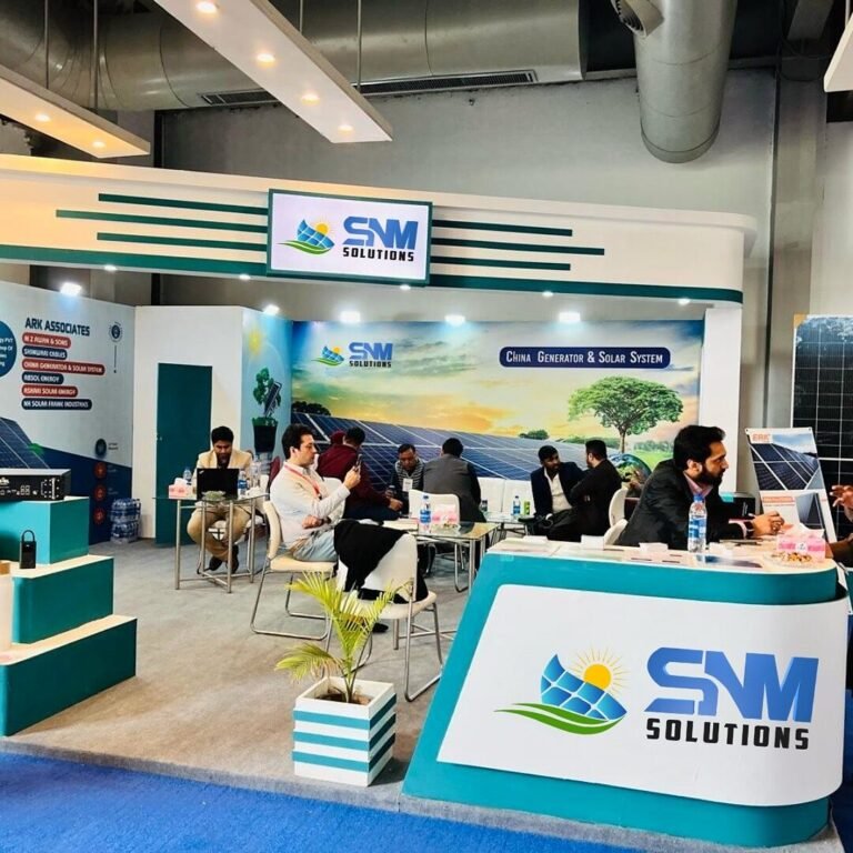 SNM Solutions exhibition booth with visitors in discussion