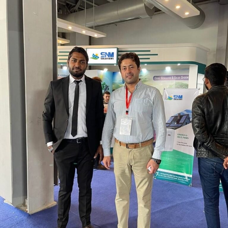SNM Solutions team outside the exhibition booth